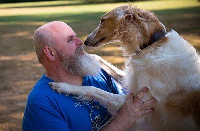 Russian Hound Greyhound with its owner